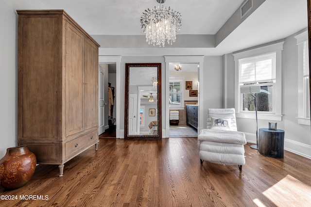 unfurnished room featuring dark hardwood / wood-style flooring and a notable chandelier