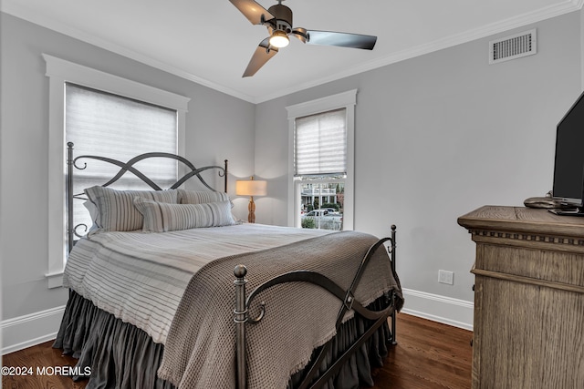 bedroom featuring dark hardwood / wood-style flooring, ornamental molding, and ceiling fan