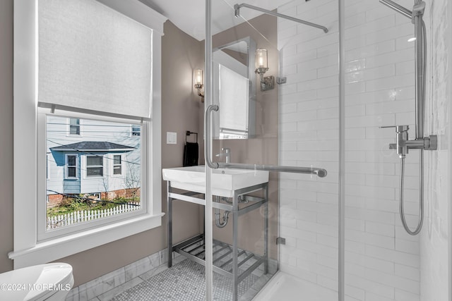 bathroom with tile patterned floors, toilet, and walk in shower