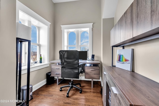 office with dark hardwood / wood-style flooring