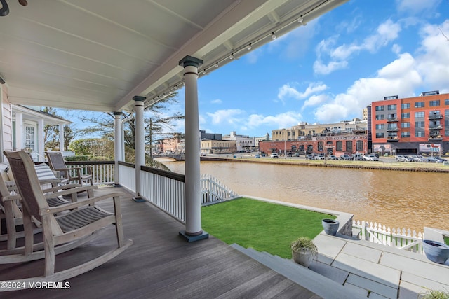 deck featuring a water view and a porch