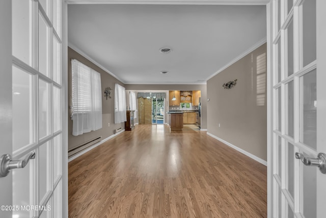 unfurnished living room featuring crown molding, light hardwood / wood-style floors, a chandelier, and baseboard heating