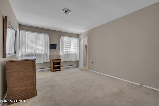 interior space with a baseboard heating unit and light colored carpet