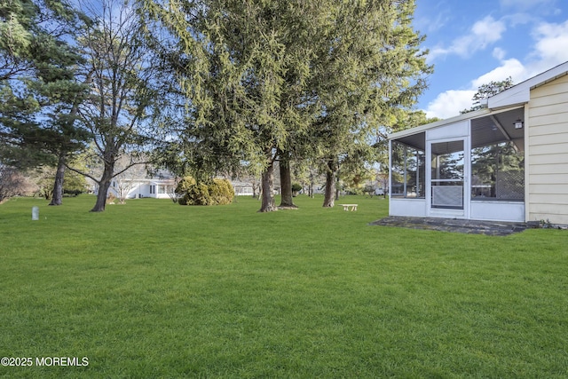 view of yard featuring a sunroom