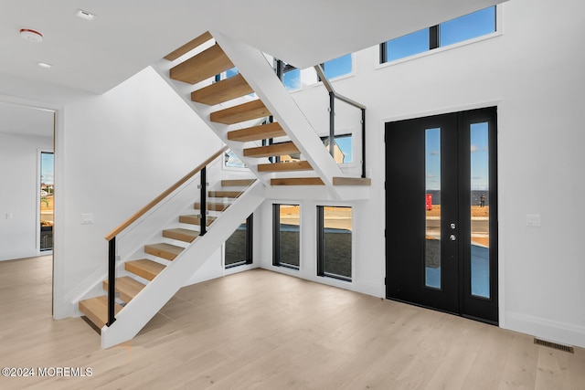 interior space with french doors and hardwood / wood-style floors