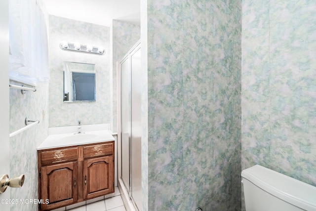 bathroom featuring walk in shower, tile patterned floors, toilet, and vanity