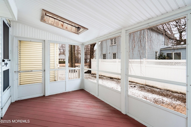 unfurnished sunroom with vaulted ceiling and a healthy amount of sunlight