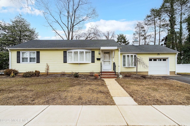 single story home with a garage and a front yard