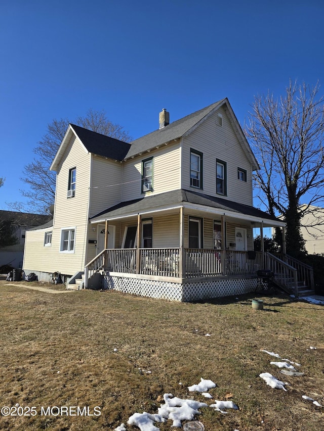 farmhouse featuring a front lawn and a porch