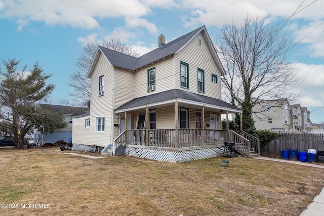 view of front of house featuring covered porch and a front lawn