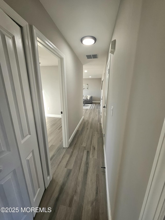 hallway featuring dark wood-type flooring