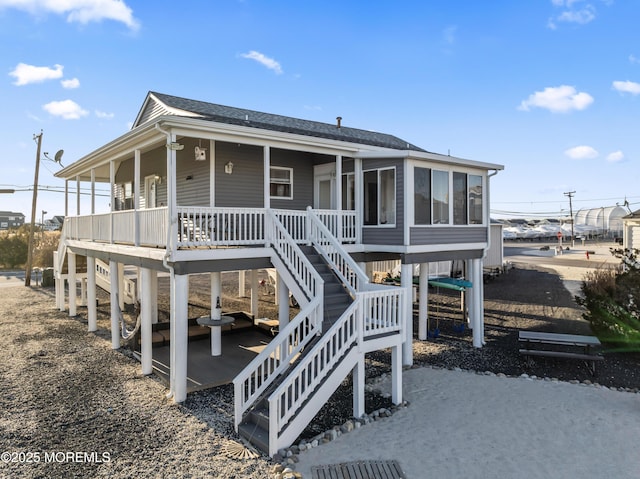 view of front of house featuring a porch and a sunroom