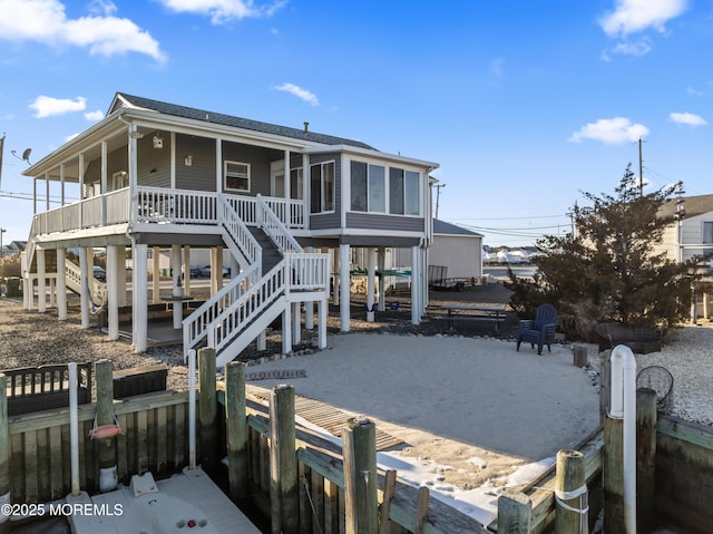 rear view of property featuring a sunroom