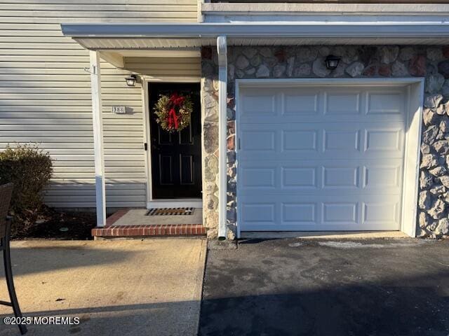 doorway to property with a garage