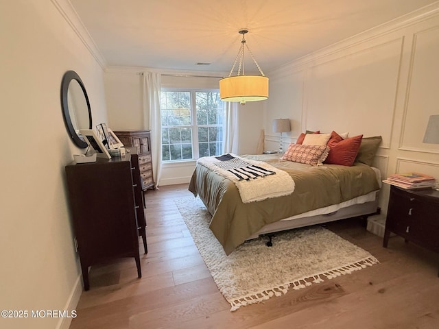 bedroom with crown molding and wood-type flooring