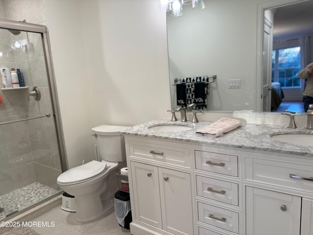 bathroom with vanity, toilet, tile patterned floors, and walk in shower