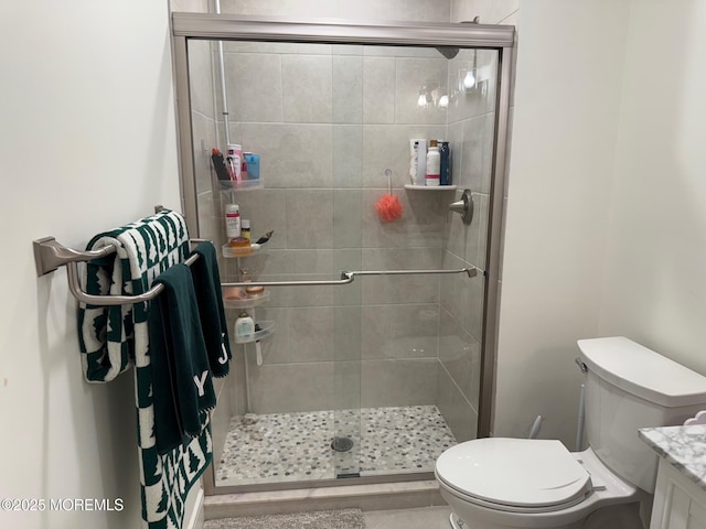 bathroom featuring walk in shower, vanity, and toilet