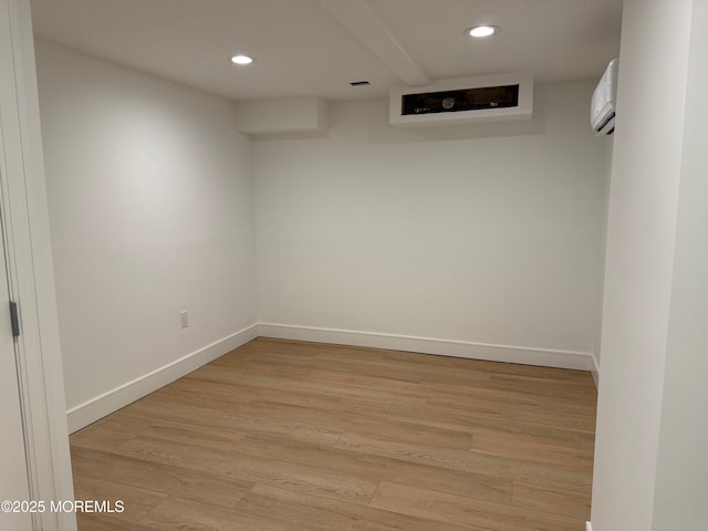 interior space with a wall mounted AC and light wood-type flooring