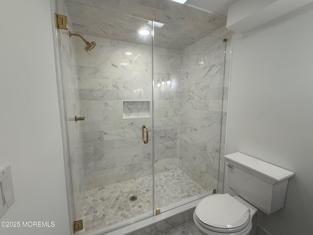 bathroom featuring an enclosed shower and toilet