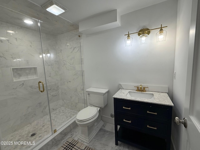 bathroom with vanity, toilet, and a shower with door