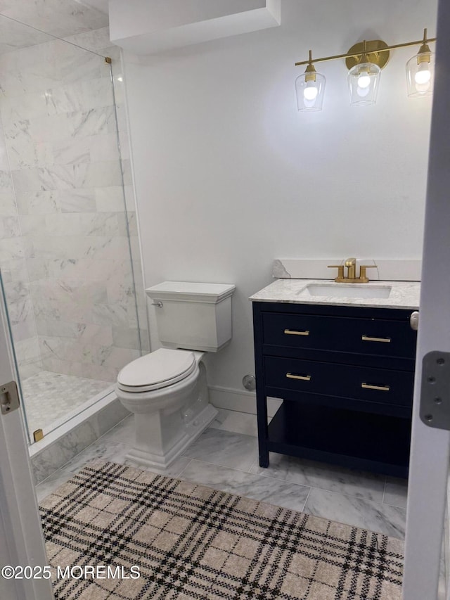 bathroom featuring vanity, toilet, and tiled shower