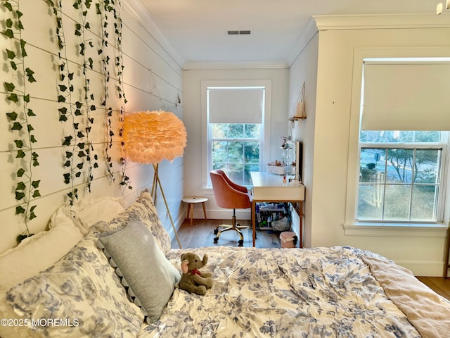 bedroom featuring hardwood / wood-style flooring and crown molding