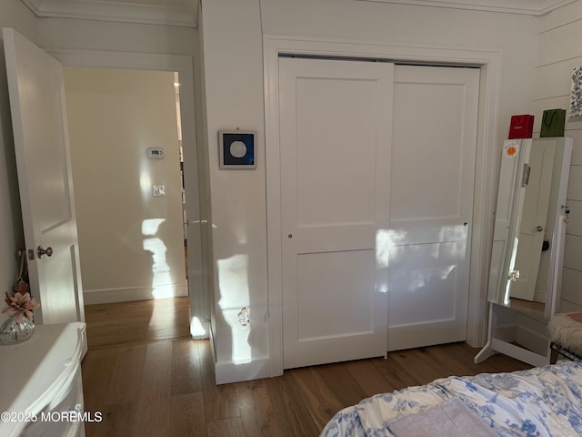 bedroom with wood-type flooring and a closet