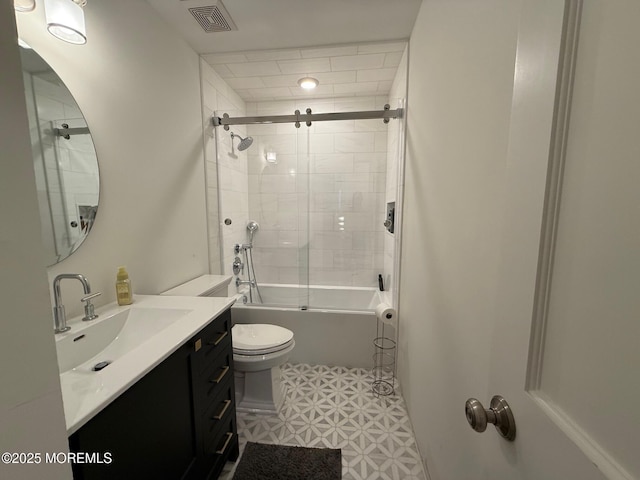 full bathroom featuring vanity, combined bath / shower with glass door, and toilet