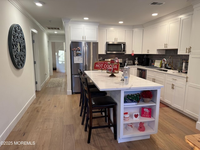 kitchen featuring appliances with stainless steel finishes, sink, and white cabinets