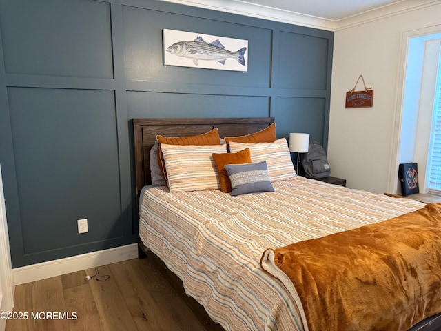 bedroom with dark hardwood / wood-style flooring and crown molding