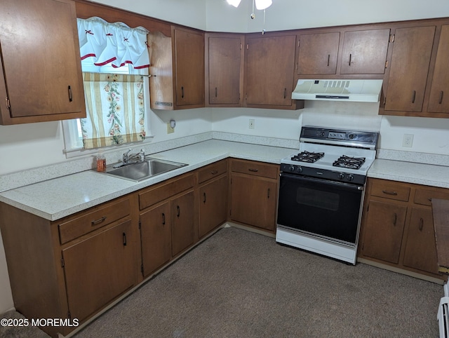 kitchen with a baseboard heating unit, sink, range with gas stovetop, and range hood