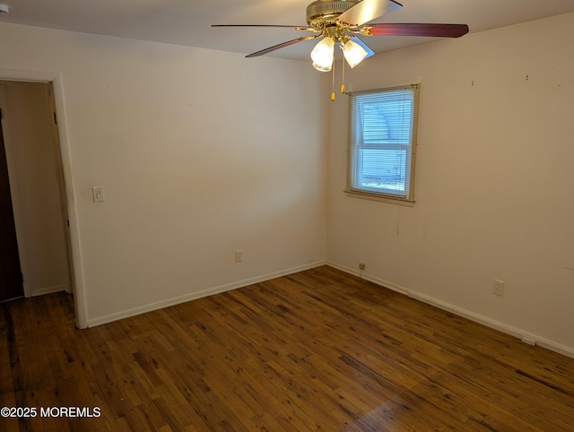 unfurnished room featuring ceiling fan and dark hardwood / wood-style flooring