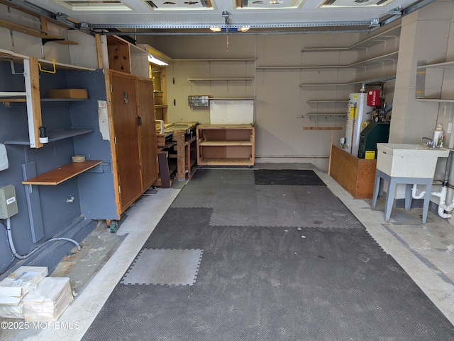 garage featuring water heater and a workshop area