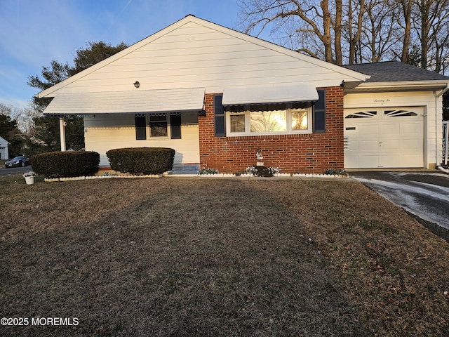 view of front of house with a garage and a front lawn