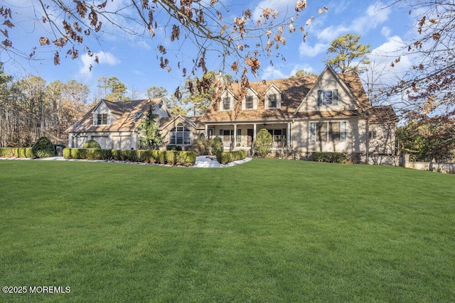 view of front of home with a front yard and a porch