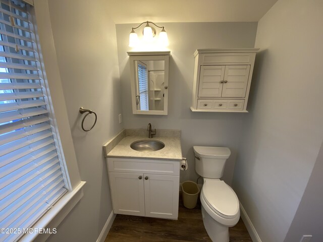 bathroom with vanity, hardwood / wood-style floors, and toilet