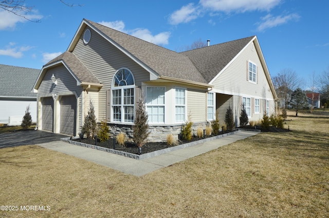 view of front of property with a garage and a front lawn