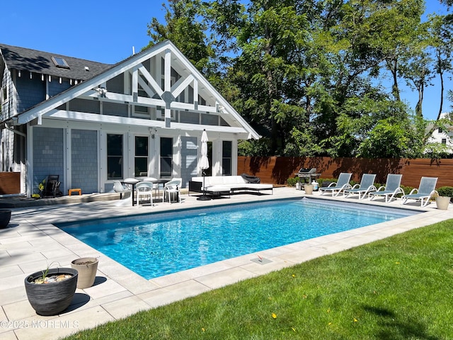 view of pool with an outdoor living space, an outdoor structure, and a patio