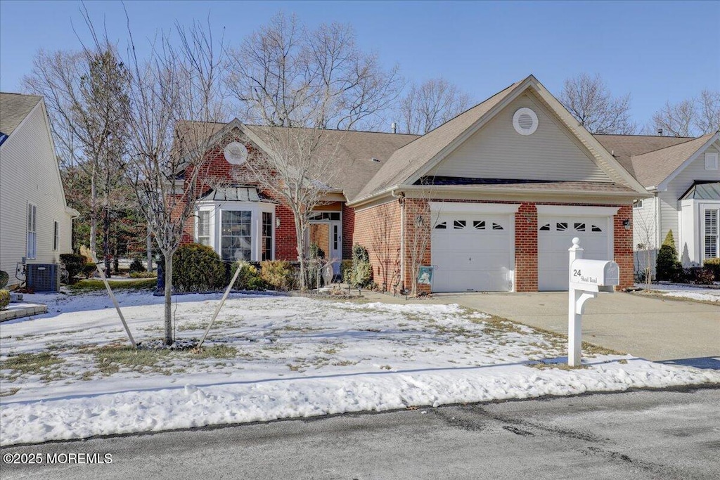 view of front of house with a garage and central AC unit