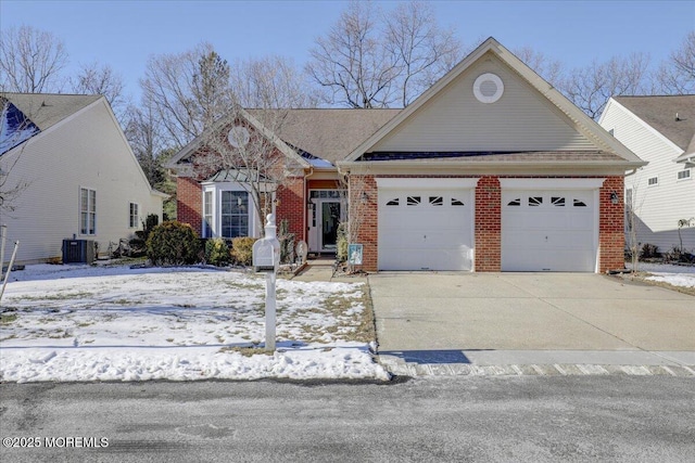 view of front of property with a garage and central air condition unit