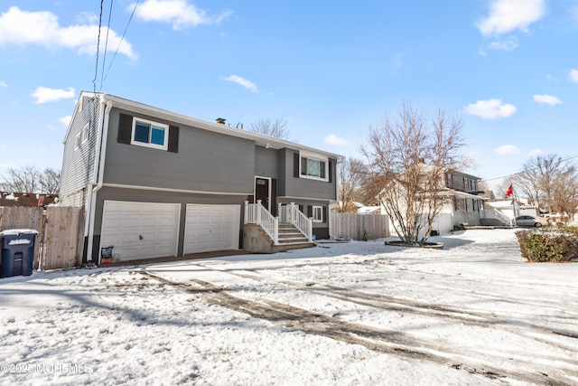 snow covered property featuring a garage