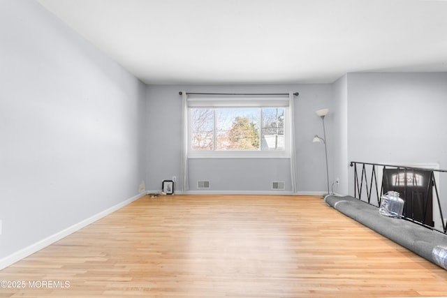 empty room with light hardwood / wood-style floors