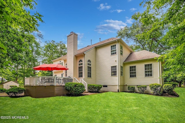 back of house featuring a yard and a deck