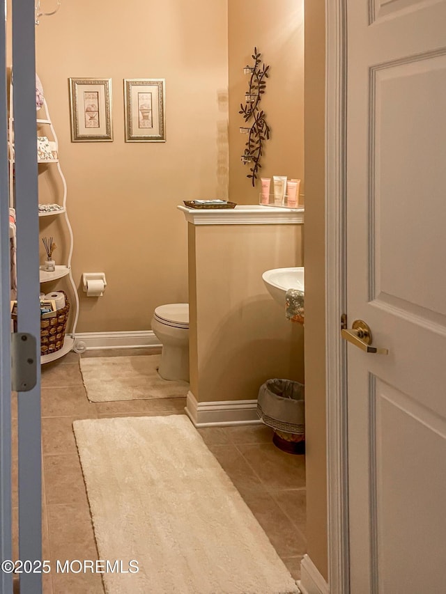 bathroom with tile patterned flooring and toilet