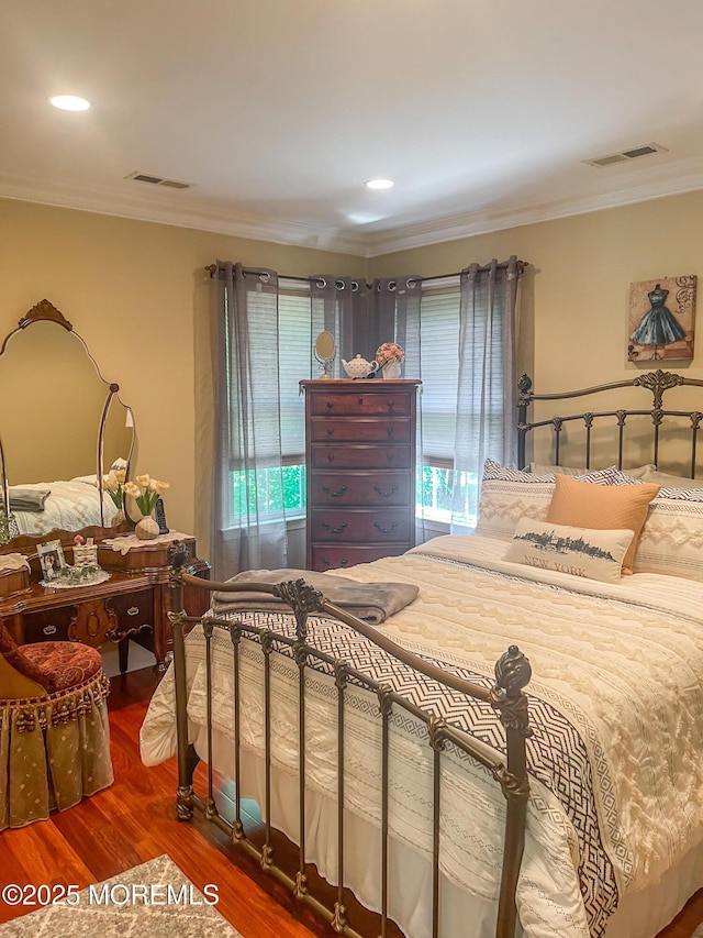 bedroom with hardwood / wood-style flooring and ornamental molding