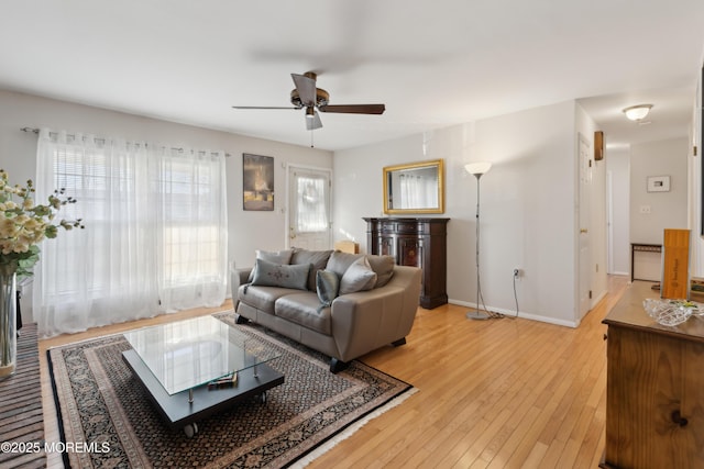 living room featuring wood-type flooring and ceiling fan