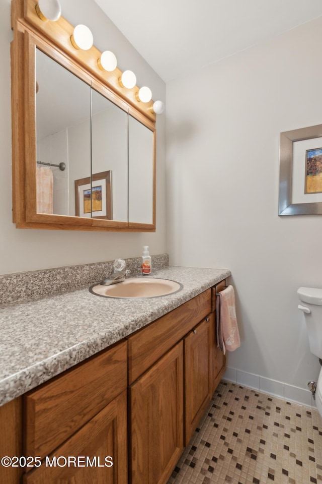 bathroom with vanity, walk in shower, and toilet