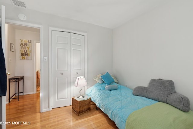 bedroom featuring wood-type flooring and a closet