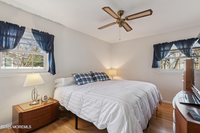 bedroom with hardwood / wood-style flooring and ceiling fan