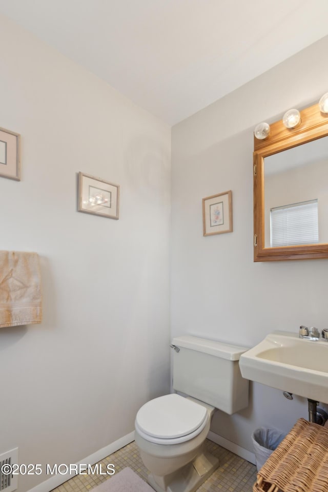 bathroom with tile patterned floors and toilet